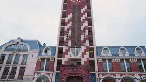 Tall red brick clock tower with geometric white pattern architectural landmar Stock Footage 341852093