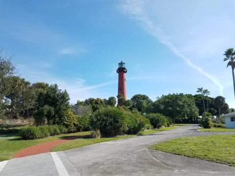 Tall red lighthouse in Florida with trees and holiday decorations Stock Photos