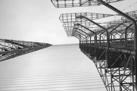 Tall rusty edifices featuring a complex network of wires. Duga Stock Photos