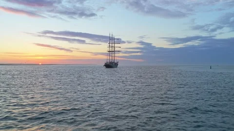 Tall sailing ship floating on the sea at sunset 動画素材 340349405