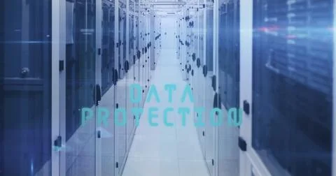 Tall server cabinets lining long corridor displaying DATA PROTECTION text in Stock Photos