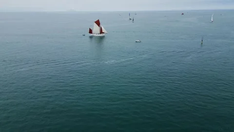 Tall ship Le Bische leaving the port of Ouistreham, France. 4K drone footage Stock Footage 313362926