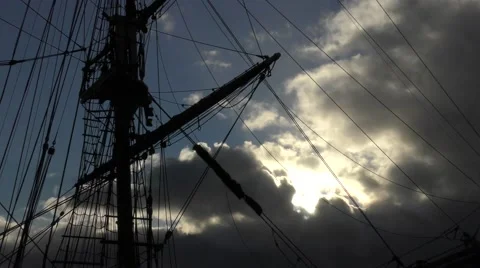 Tall ship mast rigging dramatic backlit sky Stock Footage 60006052