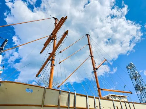 Tall ship masts and clouds on a bright day at the harbor Stock Photos