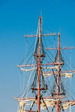 Tall ship masts and rigging against clear blue sky Stock Photos