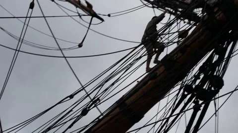 Tall ship sailor climbing onto the bowsprit Stock Footage