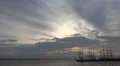 Tall ships leaving harbor at cloudy sunset time HD Footage