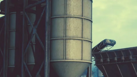 Tall silos at a construction site under a cloudy sky Vidéo 344851127