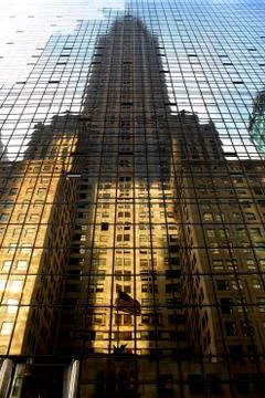Tall skyscraper reflection in another glass building Stock Photos