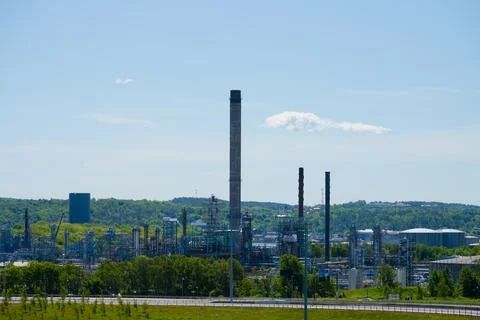 Tall smoke stack at an oil refindery Stock Photos