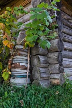 A tall stack of iron buckets stand in the corner of a wooden house Stock Photos