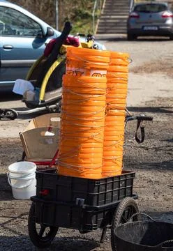 Tall Stacks of Orange Plastic Buckets in a Utility Cart for a Volunteer Clean Stock Photos