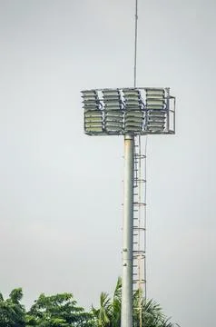 Tall stadium floodlight tower with grid style LED lamps and ladder, set aga.. Stock Photos