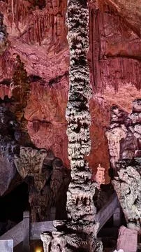 Tall Stalagmite Column Inside Illuminated Cave in China Stock Photos