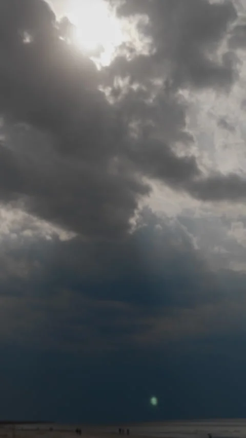Tall storm column over open sea and distant shoreline, heavy cloud curtain and 스톡 동영상 334012489