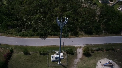 Tall Telecommunications Tower in Pioneers Loop Neighborhood, Freeport Aerial Stock Footage 90105554