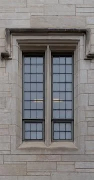 Tall thin window on old cement brick building Stock Photos
