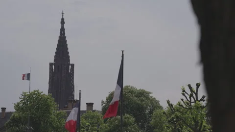 A tall tower against the backdrop of fluttering flags Stock Footage 325320422