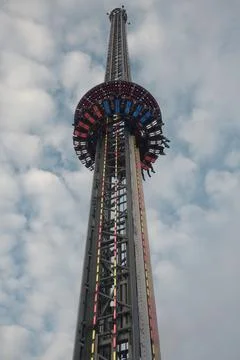 A tall tower with a roller coaster on top Stock Photos