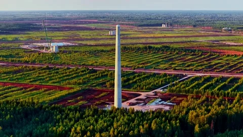 Tall tower standing in a vast, patterned rural landscape Stock Footage 334267511