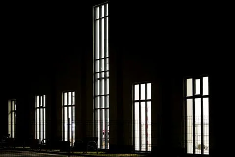 Tall vertical windows with silhouetted interior Stock Photos