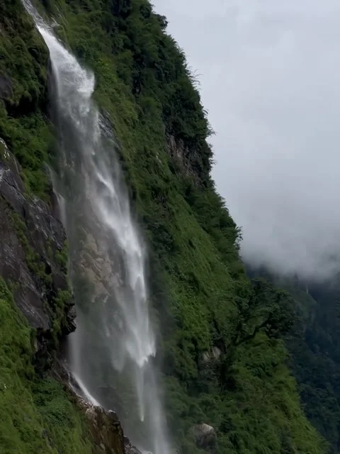 Tall Waterfall Cascading Down Green Mountain Cliff Stock Footage 340868764