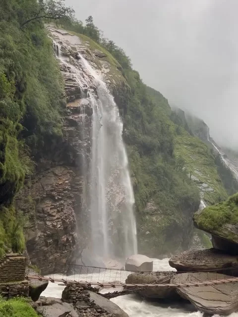 Tall Waterfall Cascading Over Rocky Mountain Cliff Stock-Footage 340868738