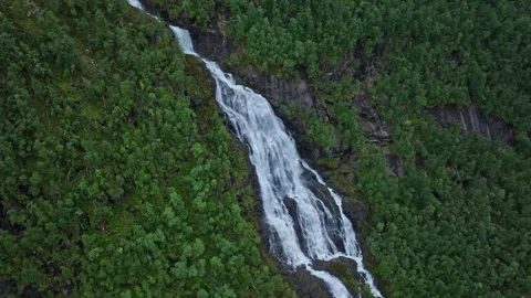 Tall waterfall cutting through rocky cliff at Flesefossen in Norway. Stock Footage 328132711