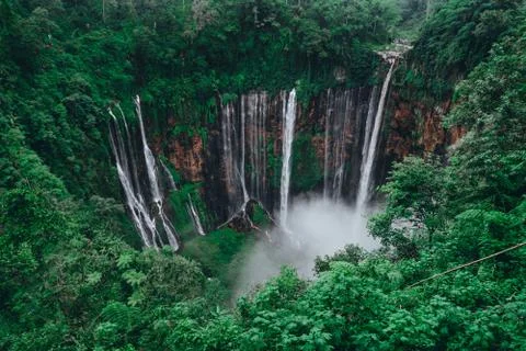 Tall waterfall in the middle of a forest on Java Island Fotos de archivo