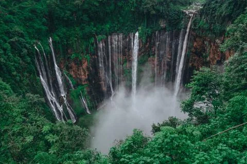 Tall waterfall in the middle of a forest on Java Island Fotos de archivo