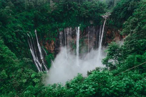 Tall waterfall in the middle of a forest on Java Island Fotos de archivo