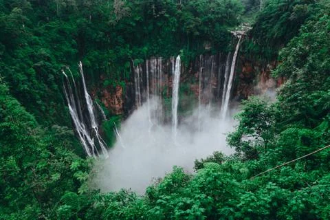 Tall waterfall in the middle of a forest on Java Island Fotos de archivo