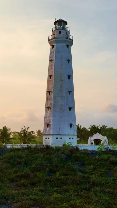 Tall white lighthouse standing in evening light Stock Footage 335432638