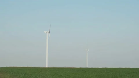 Tall wind generators rotating in slow motion. Video stock 146272223
