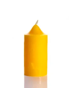 Tall yellow wax candle on white Stock Photos