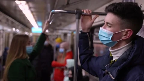 Tall young man in face mask riding in subway train Stock-Footage 149621453