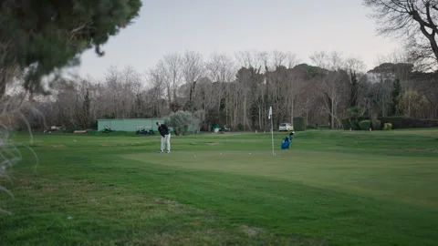 A tall young man hitting a golf shot Stock Footage 270788871
