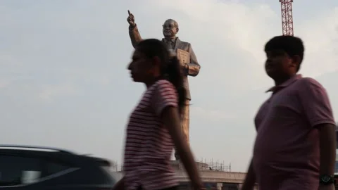 Tallest statue of Ambedkar with people in the foreground walking Stock Footage 239223606