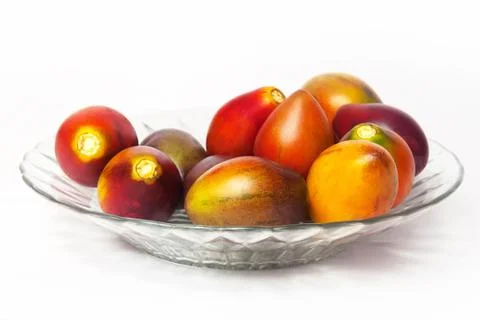 Tamarillo in a plate on a white background Stock Photos