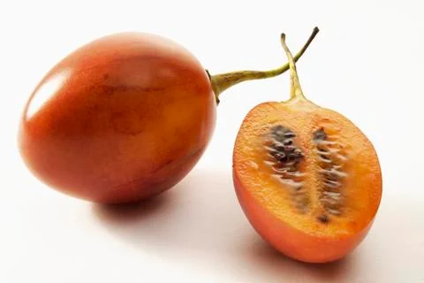 Tamarillo, whole and half Stock Photos