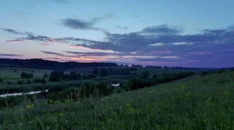 Tame laps. Sunset over the forest and field. Darkness. Stock Footage 65429186