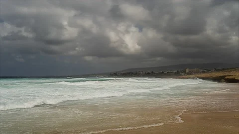 Tame lapse of stormy big breaking sea waves on sandy beach and fast moving cloud Stock-Footage 201436360