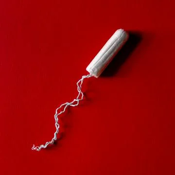 Tampon on dark red background Stock Photos