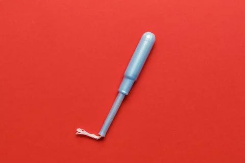 Tampon in packaging on a red background. Stock Photos