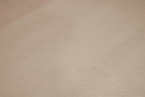 A tan fabric with a pattern of squares Stock Photos