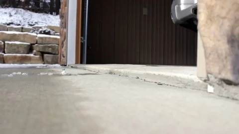 Tan SUV pulling out of garage in winter Stock Footage 70532857