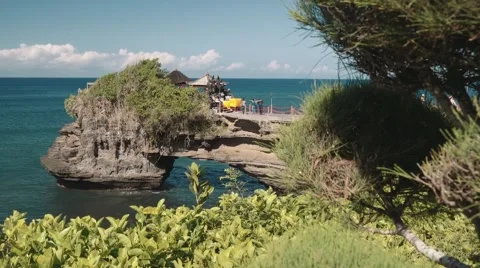 Tanah Lot temple, moving camera with bushes in foreground Video stock 61910090