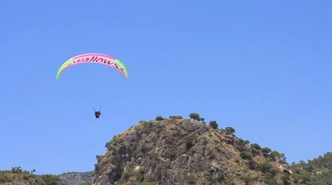 Tandem paraglider flying close to camera on sunny, summer day at the Oludeniz Stock Footage 61179976