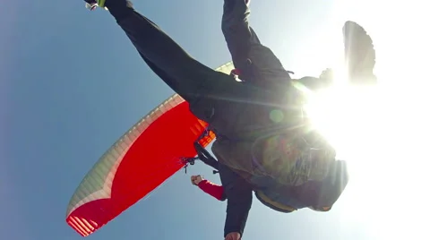 Tandem paragliding flight view from bellow against sun Stock-Footage 44202252