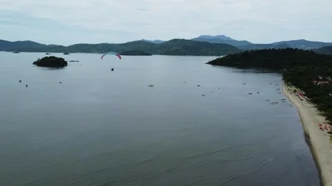 Tandem paramotor flying close to the Jabaquara Beach in Paraty, Brazil 스톡 동영상 328349655